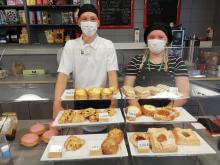 mies ja nainen seisovat kahvilan tiskin takana